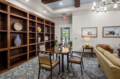 A cozy common area with bookshelves and seating