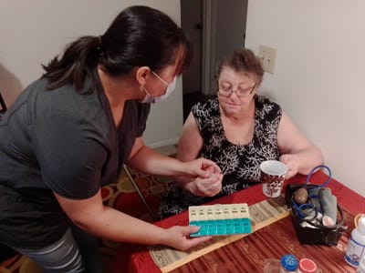Caregiver assisting a senior resident with medication