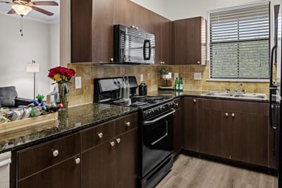 Modern kitchen interior with appliances and fresh flowers