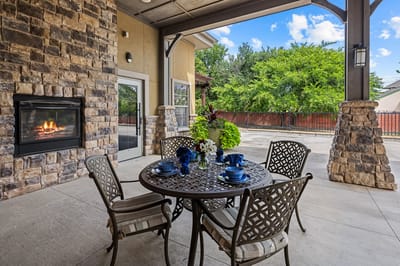 Outdoor patio area with seating and fireplace
