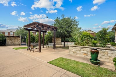 Outdoor seating area with pergola and decorative plants