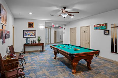 Interior game room with a pool table and seating