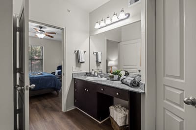 Bathroom area with modern fixtures and a bedroom visible