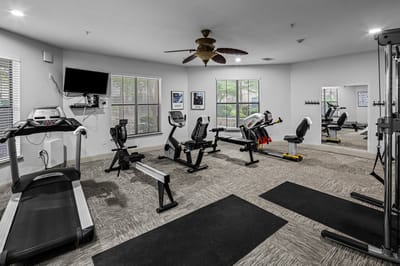 Fitness area with exercise equipment and mirrors