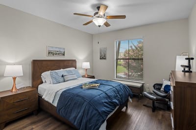 A well-furnished resident bedroom with natural light