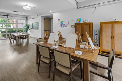Art supplies set up for residents' painting activity in the common area