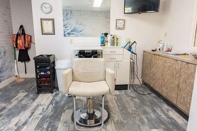 Interior view of a salon area with a styling chair