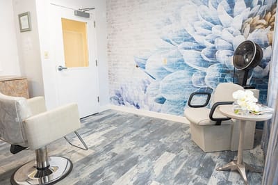 Bright salon area with floral wall mural