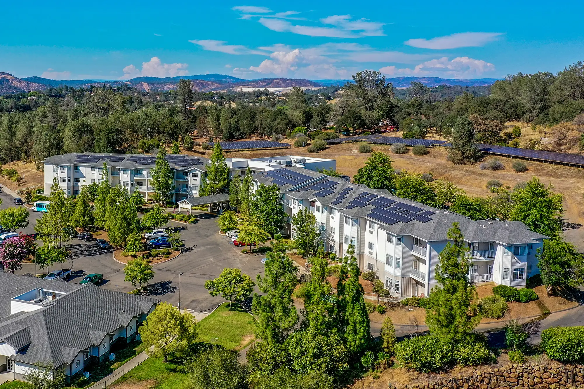 Aerial view of a senior living facility with solar panels
