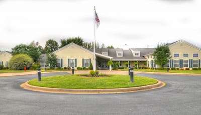 Exterior view of Walking Horse Meadows with flag and landscaping