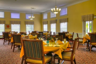 Dining room setup with tables and chairs