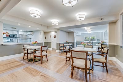 Bright dining room with tables and flower arrangements