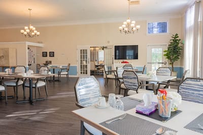 Bright dining area with tables and chairs set up
