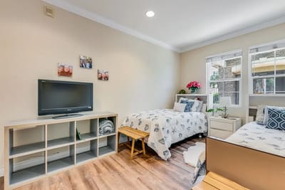 Cozy resident room with two beds and a TV