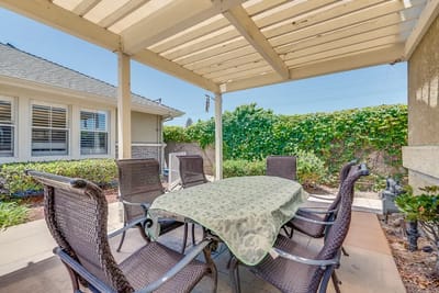 Covered outdoor seating area with a table and chairs