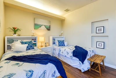 Cozy twin bedroom setup with nautical decor