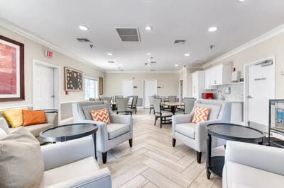 Bright common area with seating and dining tables