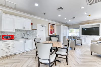 Bright communal area with seating and a kitchenette