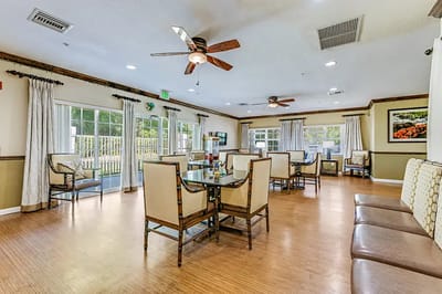 Bright common area with seating and large windows