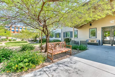 Outdoor seating area with a tree and flowers