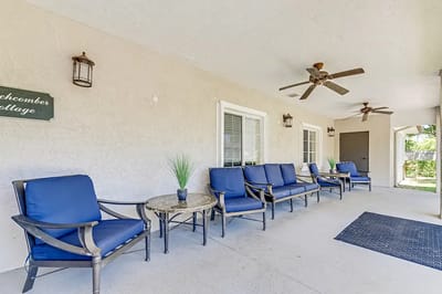 Outdoor seating area with blue chairs and a table