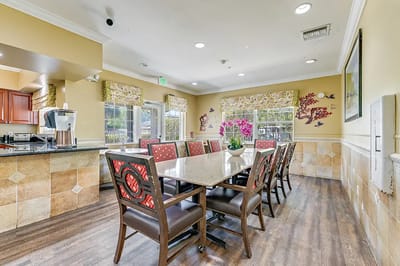 Dining area with a large table and floral decorations
