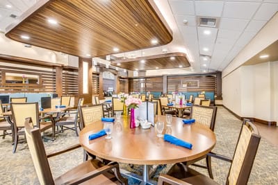 Dining area setup with tables and flowers