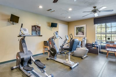Fitness room with exercise equipment in a bright interior
