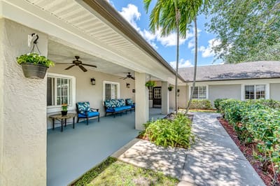 Outdoor seating area with palm trees and seating