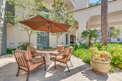 Outdoor seating area with a patio umbrella and flowers