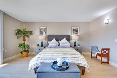 A well-decorated private resident room with a bed and plants