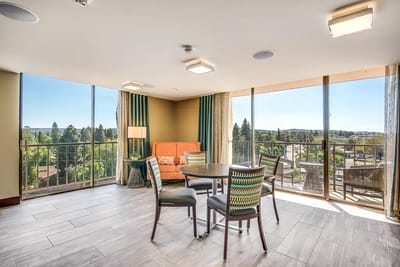 Bright common area with seating and large windows