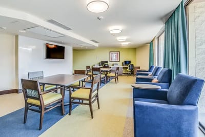 Bright common area with seating and tables
