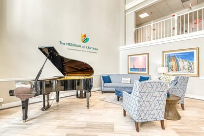 Interior lobby area with a piano and seating