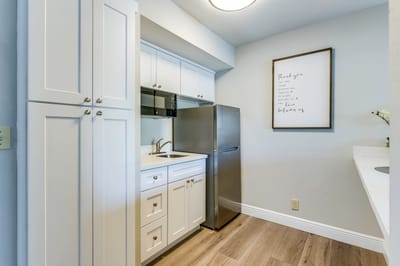 Bright, well-organized kitchenette area in a senior living facility