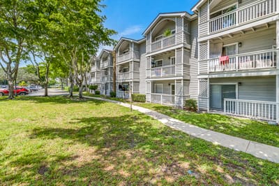 Exterior view of the assisted living facility with gardens