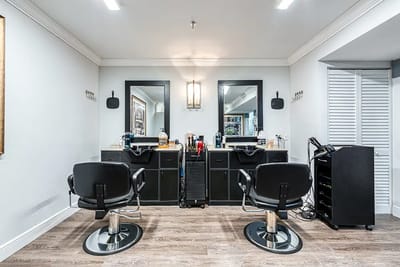 Interior view of a hair salon with two chairs