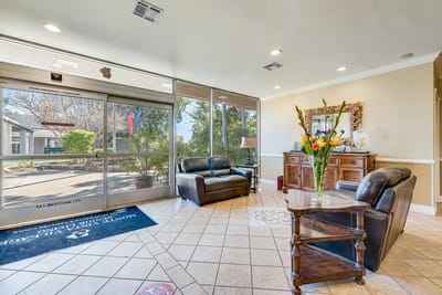 Bright lobby area with seating and view of outdoor space