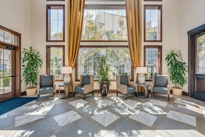 Bright lobby area with plants and seating