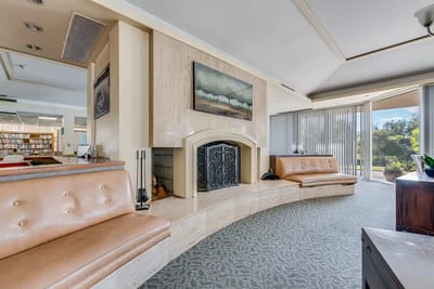 A cozy common area with seating and a fireplace