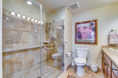 Modern bathroom interior with tiled shower and artwork