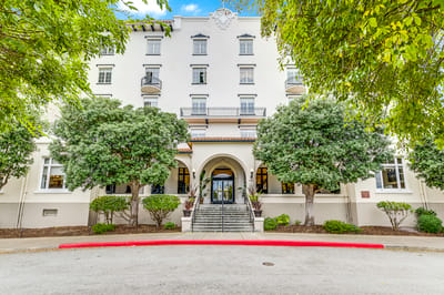 Front entrance of Pacific Grove Senior Living with landscaped area