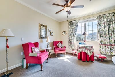 Cozy resident room with pink chairs and decorative accents
