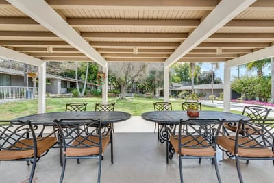 Covered outdoor seating area with tables and chairs