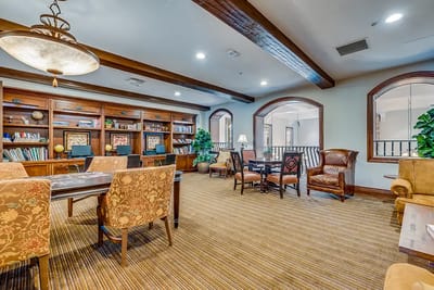 A cozy common area with bookshelves and seating