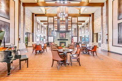 Bright common area with seating and piano