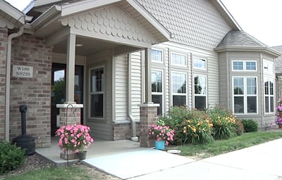 Front entrance of Vista Pointe Assisted Living with flower pots