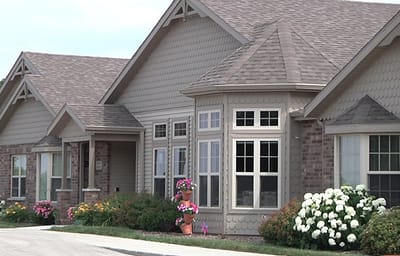 Exterior view of a senior living facility with flowers