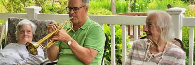Residents enjoying music in a garden area