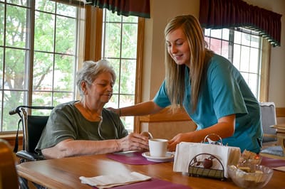 Staff member assisting a resident in a common area